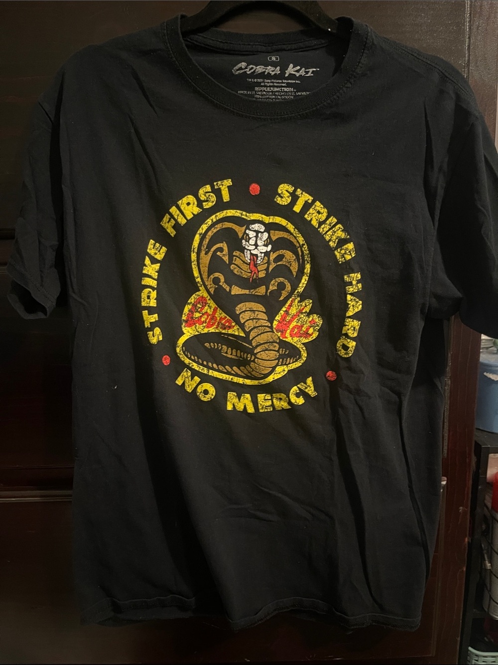 #145- Cobra Kai "Strike First No Mercy" Black Graphic Tee